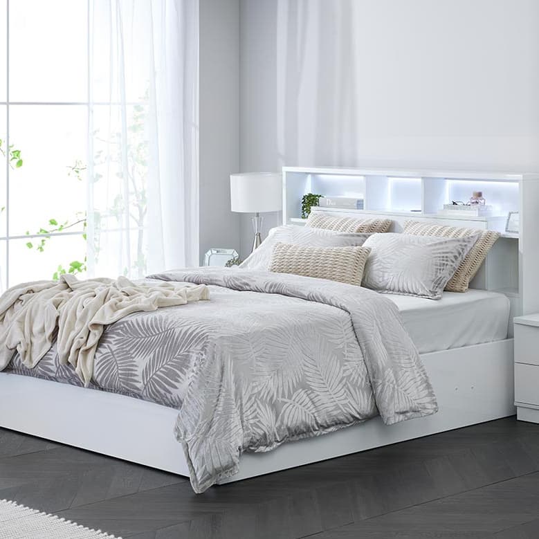 Lifestyle image of the Argo Gloss White Qb Bed W/Gas Lift & End Drawer Base from Forty Winks